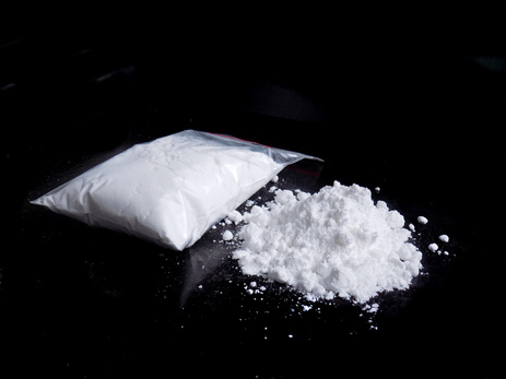 Cocaine drug powder in bag and cocaine powder pile
